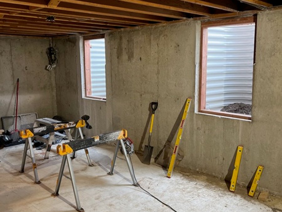 Basement egress window installation with concrete foundation framing