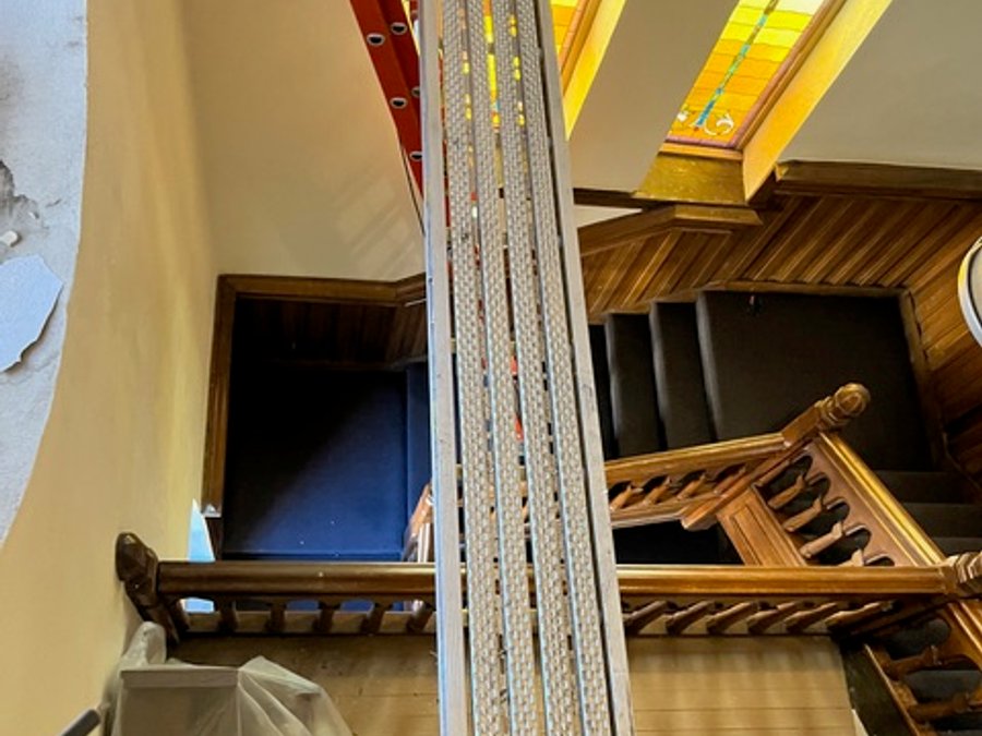 Cathedral restoration with high-ceiling work and scaffolding near stained glass
