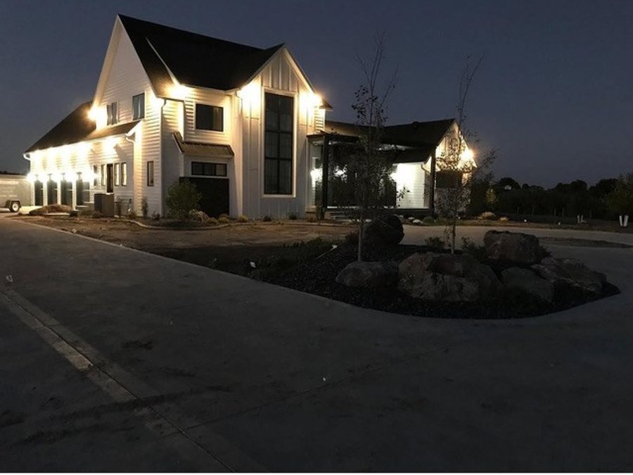 Custom modern farmhouse build at night with landscape lighting in Elbert County, Colorado