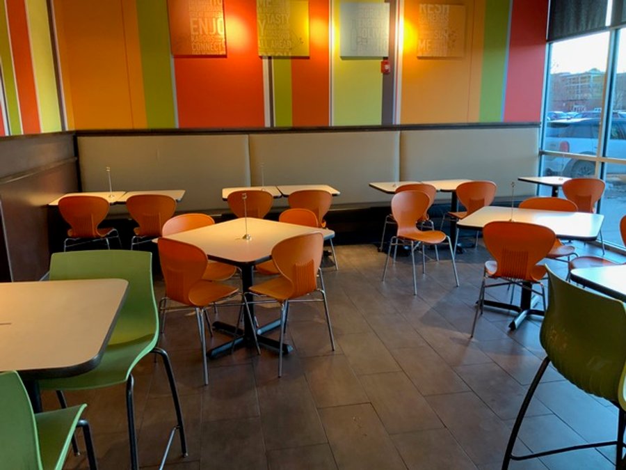 Restaurant booth seating with colorful walls in a finished commercial build