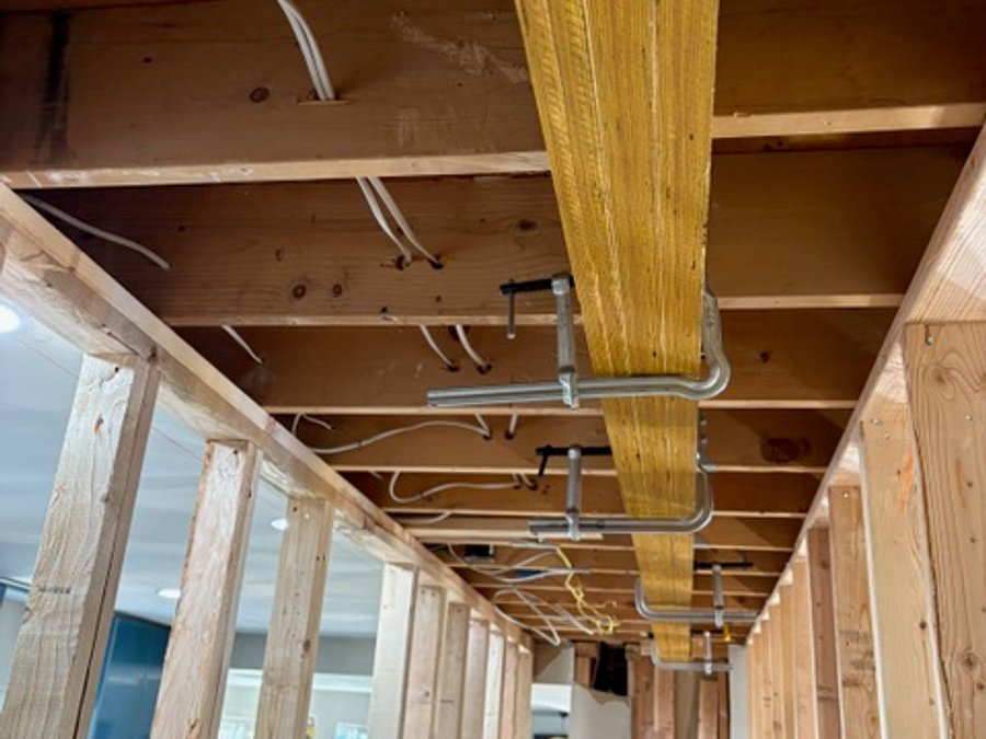 LVL engineered beam installation secured with ratchet straps