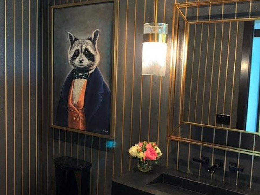 Luxury powder room with navy-and-gold pinstripe wallpaper, a black toilet, and a cage-style mirror