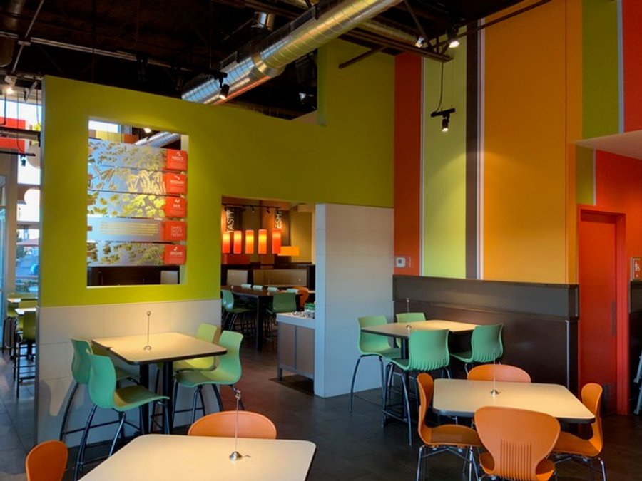 Restaurant tenant improvement showing dual dining areas with green accent walls