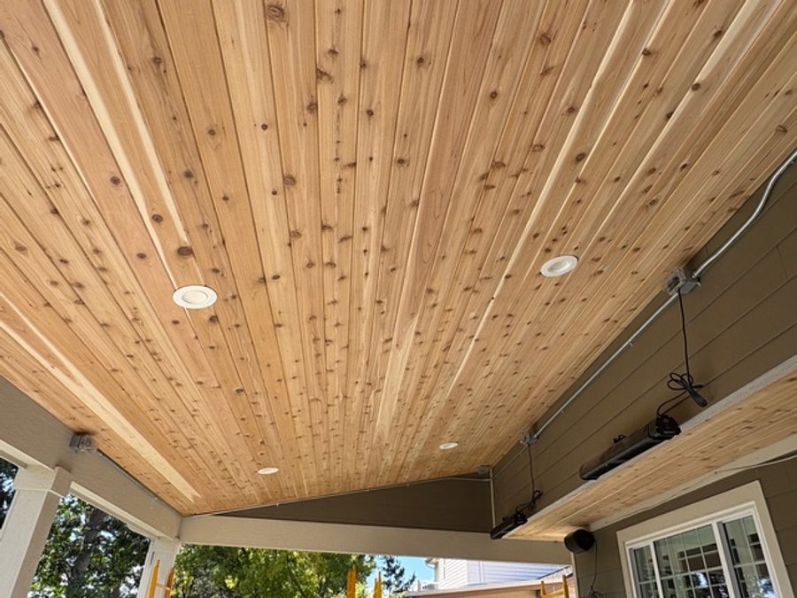 Close-up of cedar tongue-and-groove finish carpentry with recessed lights