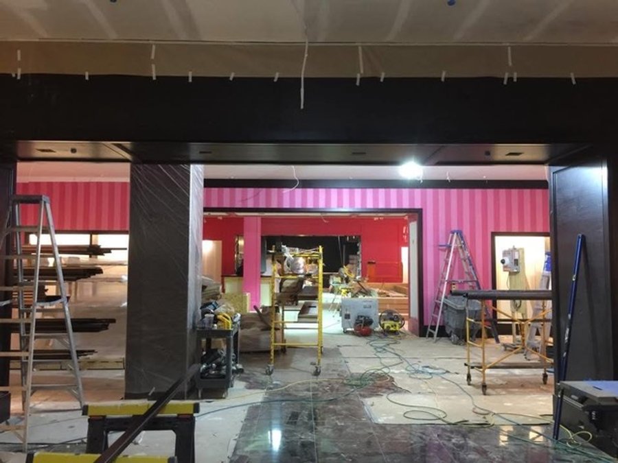 Victoria's Secret storefront in a mall corridor with pink-stripe accent walls