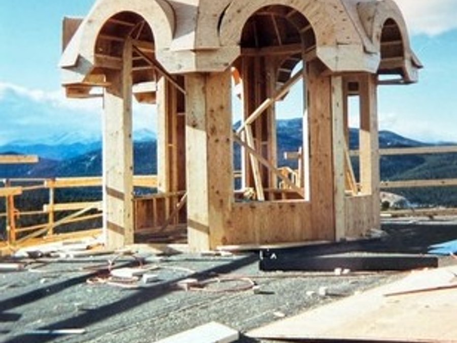 Castle cupola framing with octagonal arched openings and Colorado peaks beyond