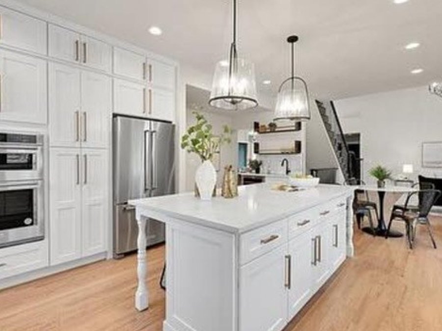Full-height cabinetry with a double wall oven in the remodeled kitchen