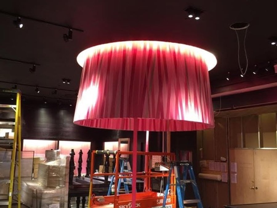 Victoria's Secret drum pendant light installation over a checkered floor