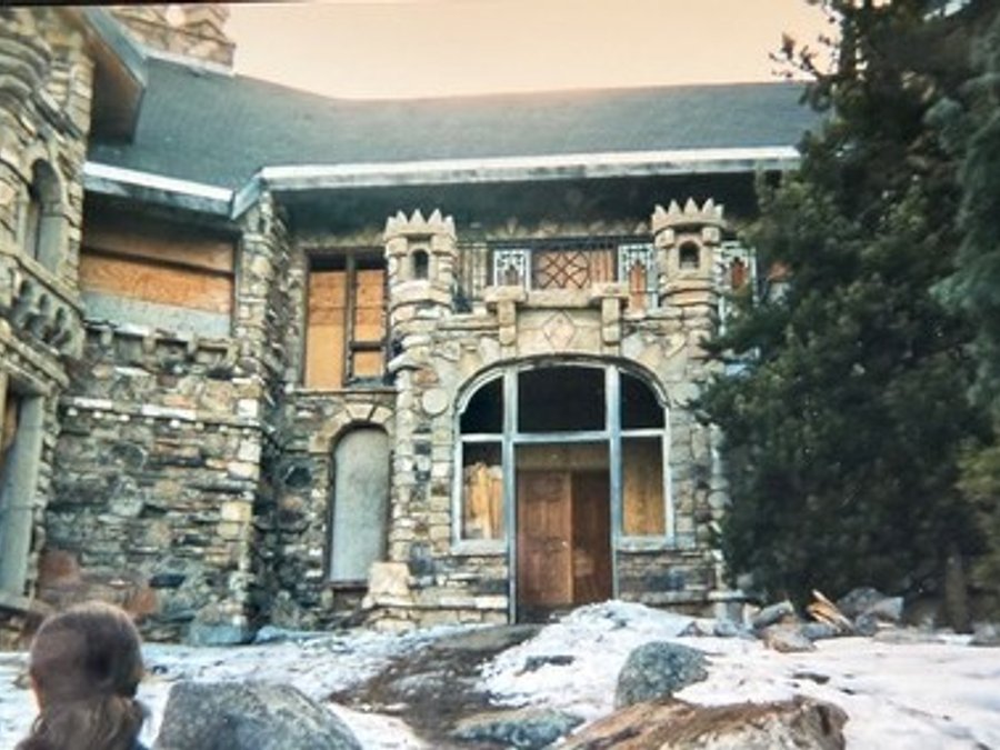 Castle stone exterior with crenellations and an arched entry