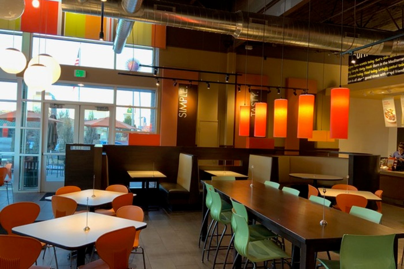Finished commercial restaurant build with pendant lights and booth seating by Engle Construction Group