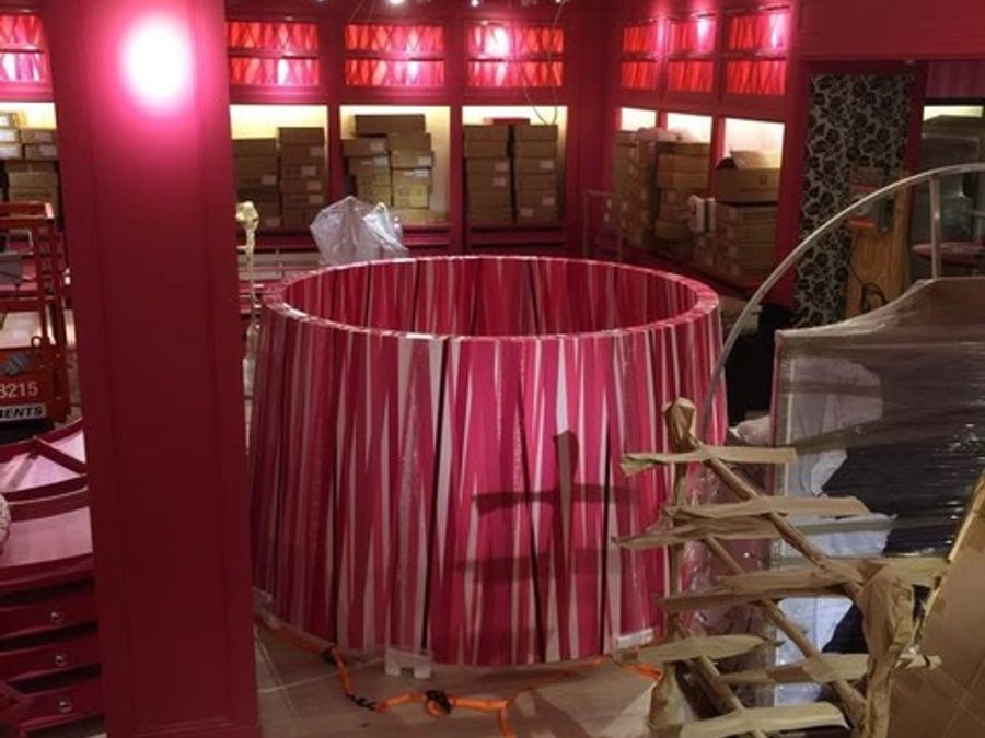 Wide view of the Victoria's Secret buildout with drum shade lighting and display shelving