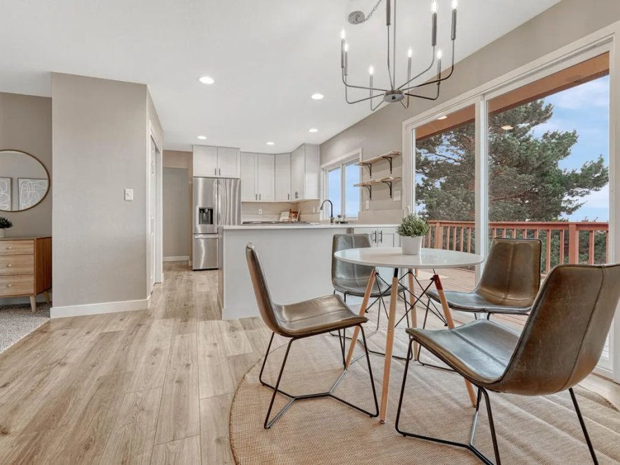 Finished: open-plan kitchen and dining with hardwood flooring, chandelier, and Colorado views