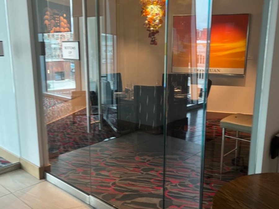 Private dining room with glass wall art and chandelier