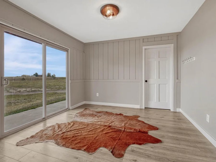 Finished: mudroom with shiplap accent wall, sliding door, and Colorado acreage views