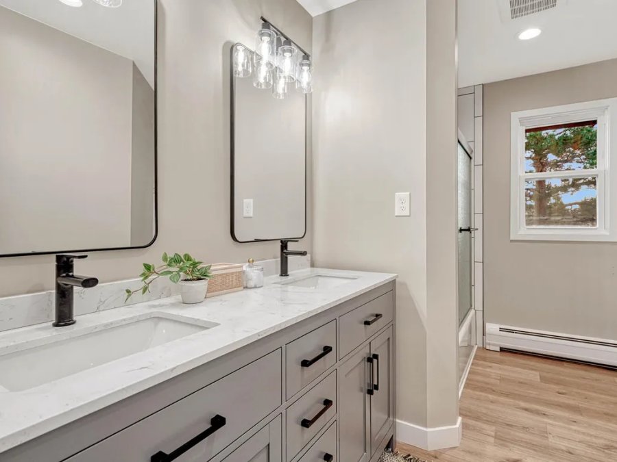 Finished: master bathroom with double vanity, marble quartz countertop, and black fixtures