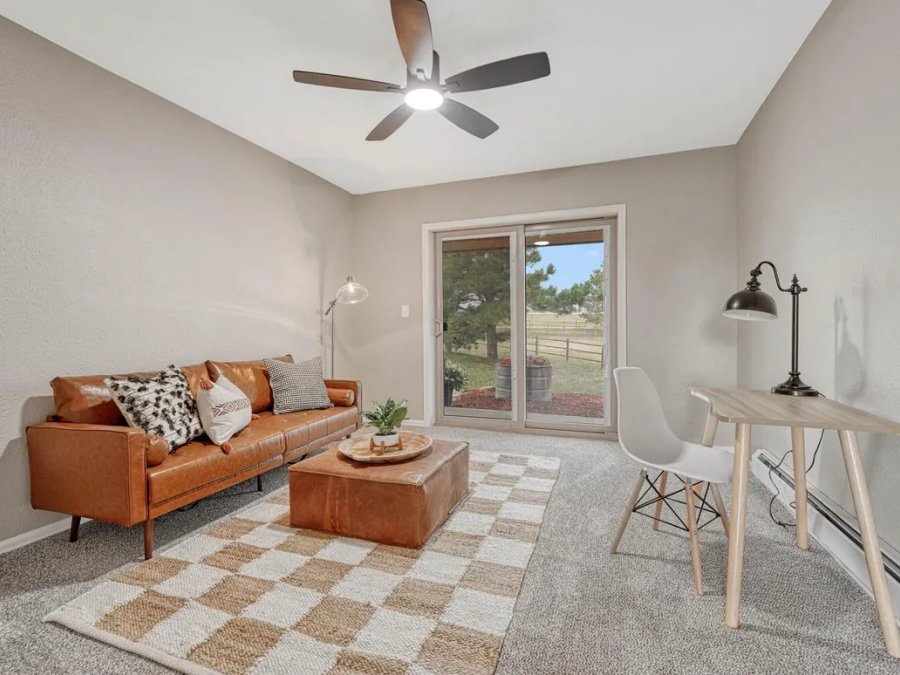 Finished: sitting room with leather sofa, carpet, ceiling fan, and Colorado views